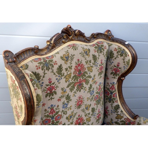 837 - A floral upholstered gilt decorated wingback chair, early 20th cen