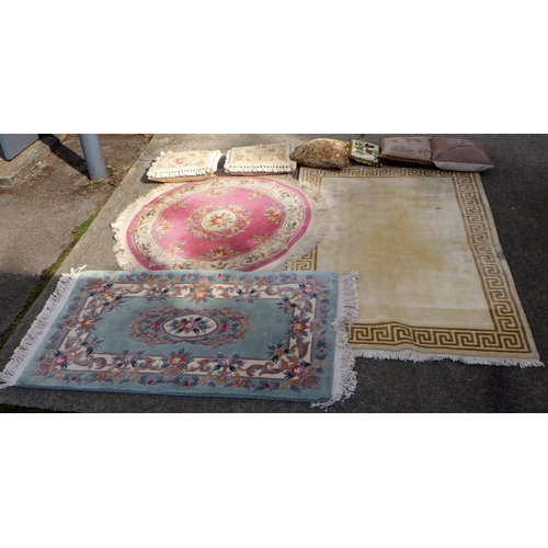 850 - Two Chinese rugs, another rug and various cushions