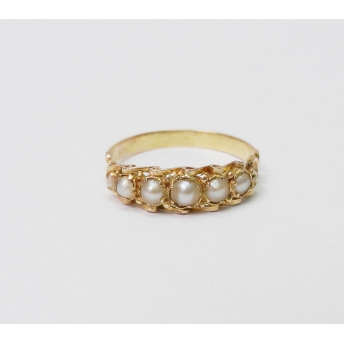 32 - A ring comprising seven graduated pearls in an unmarked yellow metal setting.