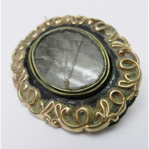 37 - A mourning brooch having central swivel panel within a 