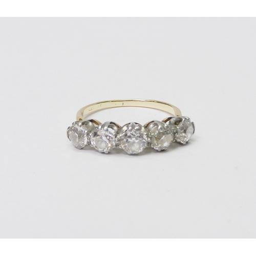 39 - A five stone ring comprising five evenly sized round cut diamonds set in white metal raised claws on... 