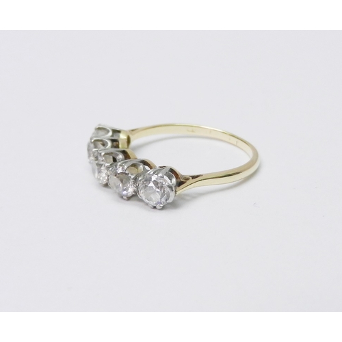 39 - A five stone ring comprising five evenly sized round cut diamonds set in white metal raised claws on... 