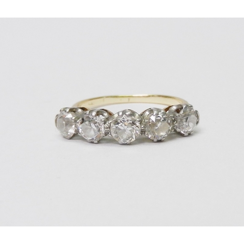 39 - A five stone ring comprising five evenly sized round cut diamonds set in white metal raised claws on... 