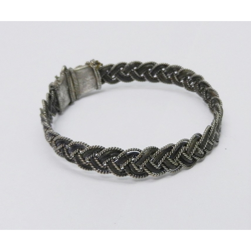 48 - A sprung bracelet, white metal and elephant hair, approximately 60mm across; two turquoise set brooc... 