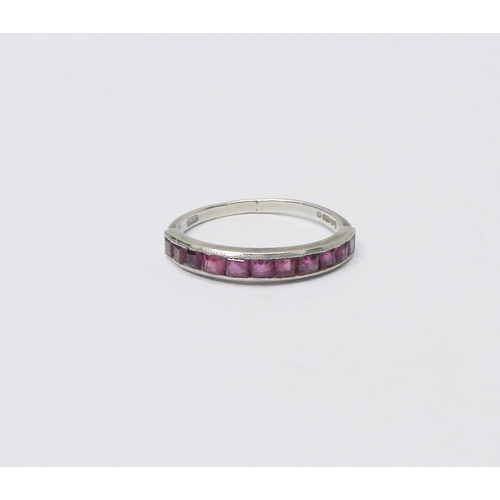 50 - A half hoop ring, 9ct white gold set with eleven square cut rubies, 1.5g / SIZE.