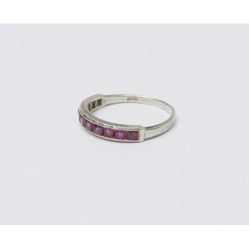 50 - A half hoop ring, 9ct white gold set with eleven square cut rubies, 1.5g / SIZE.