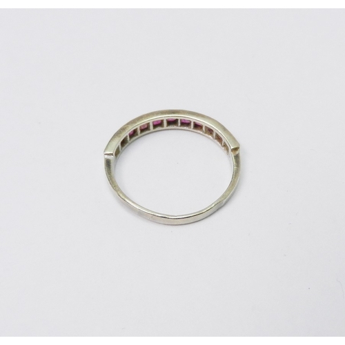 50 - A half hoop ring, 9ct white gold set with eleven square cut rubies, 1.5g / SIZE.