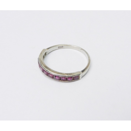 50 - A half hoop ring, 9ct white gold set with eleven square cut rubies, 1.5g / SIZE.