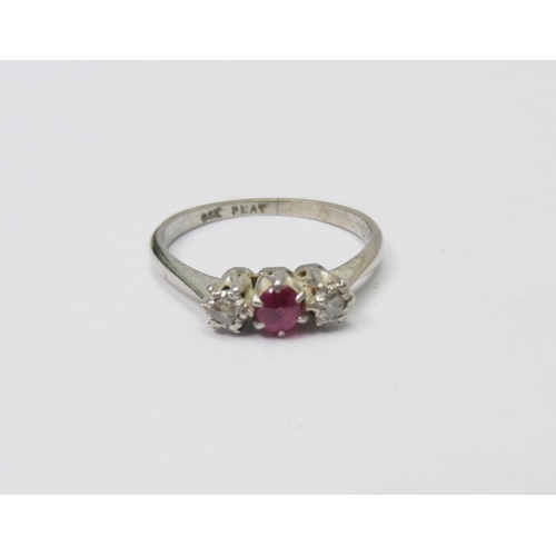 51 - A trilogy ring white metal marked 9ct and plat comprising a principal round cut ruby and two illusio... 