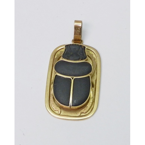 61 - An Egyptian scarab pendant inset with basalt, hieroglyphic motif inscription verso, indistinctly mar...