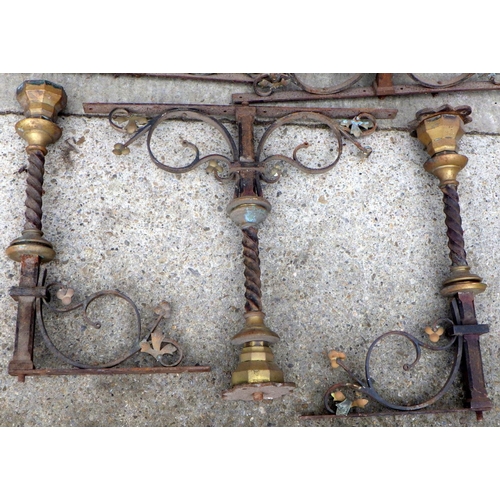 855 - A qty of wrought iron & brass balustrade hardware