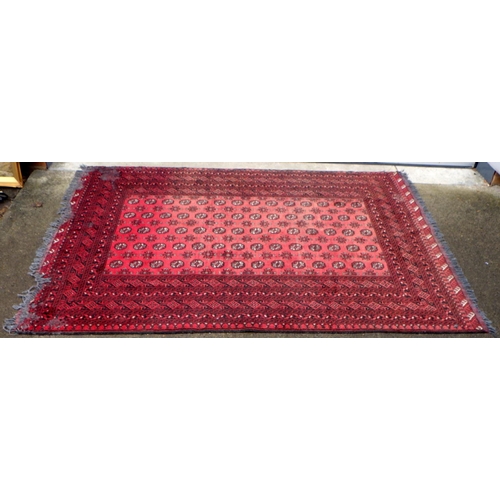 863 - A red ground carpet, moth damage, approx 290cm x 200cm together with a smaller red ground rug (2)