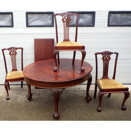 864 - A wind out dining table on ball & claw cabriole legs together with three dining chairs (4) (a/f)