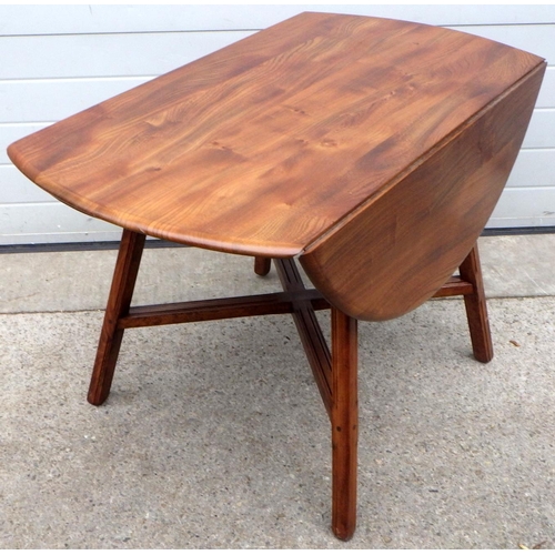 874 - A dark Ercol drop leaf dining table, 113cm across