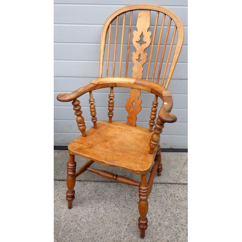 883 - A pad arm Windsor chair together with a smokers bow armchair (2)