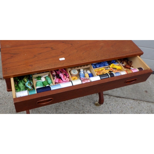 884 - A teak work table with contents, 70cm wide