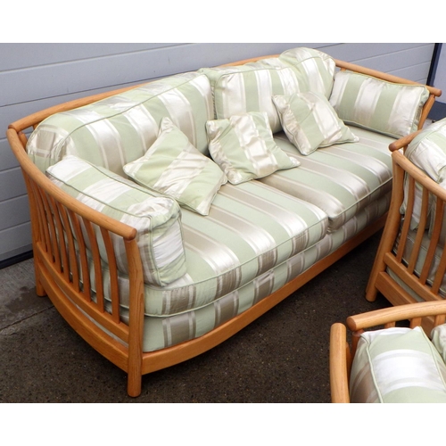 888 - A blonde Ercol three piece suite