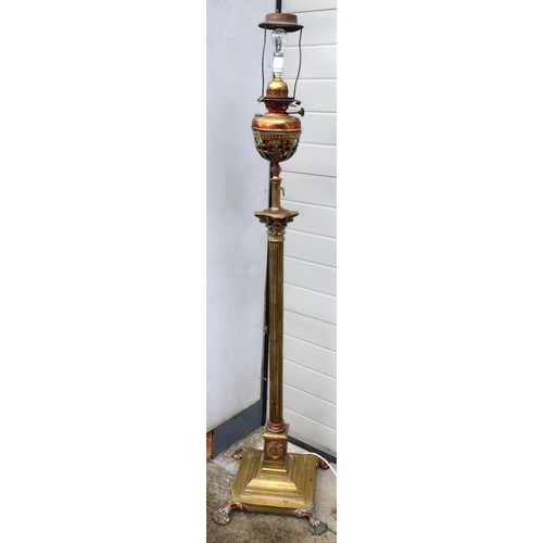 899 - A telescopic brass standard lamp with later oil lamp