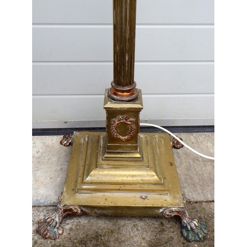 899 - A telescopic brass standard lamp with later oil lamp