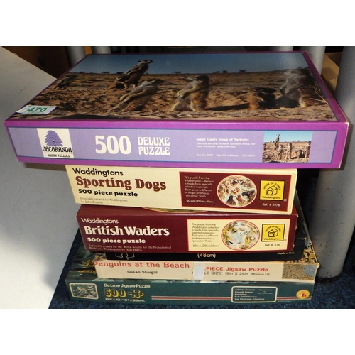 470 - A large qty of various jigsaws, train books etc