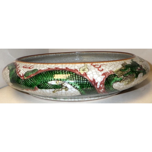 499 - A Chinese crackle glaze circular bowl decorated with dragons 27cm diameter