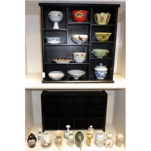 503 - Two display shelves containing miniature Oriental vases, tea bowls etc