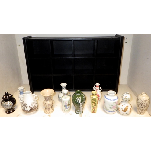 503 - Two display shelves containing miniature Oriental vases, tea bowls etc