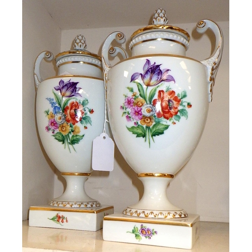 130 - A pair of porcelain Furstenberg painted urns 28cm tall