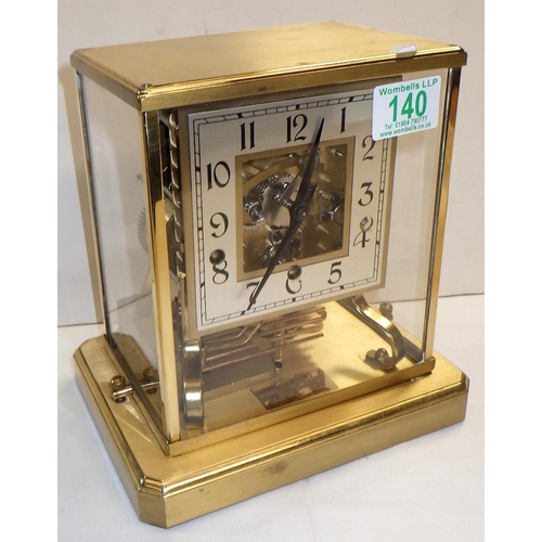 140 - A skeleton mantel clock in a brass case with perspex glazing, the German Shatz 7 jewel movement stri... 