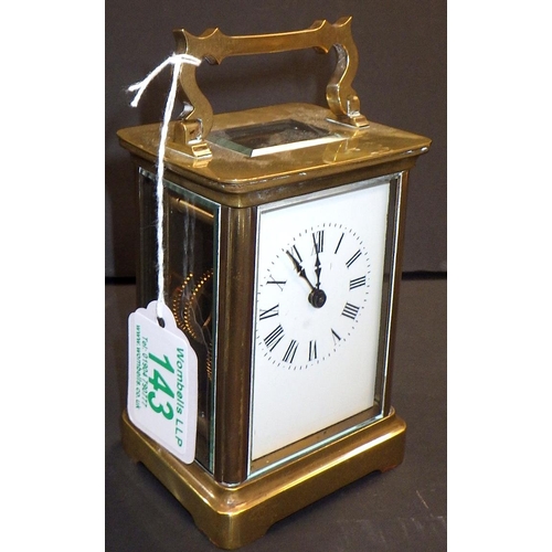 143 - A brass cased carriage clock.  11cm tall.