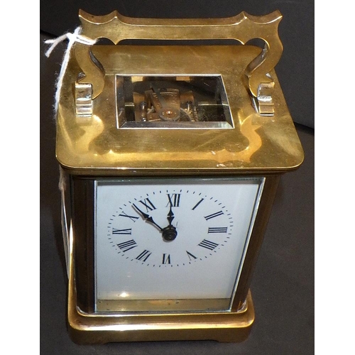 143 - A brass cased carriage clock.  11cm tall.