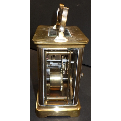 143 - A brass cased carriage clock.  11cm tall.