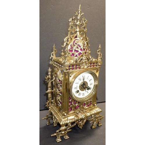 144 - A French brass cased mantel clock, the movement signed AM, striking on a single bell.  39cm tall.