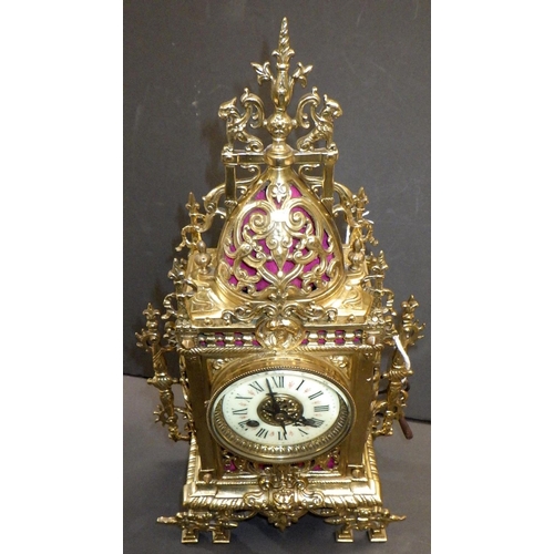 144 - A French brass cased mantel clock, the movement signed AM, striking on a single bell.  39cm tall.