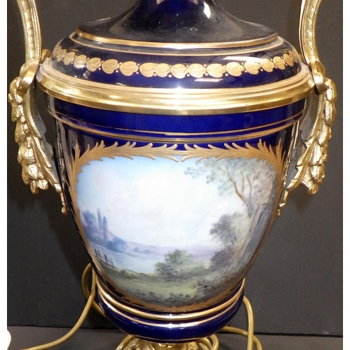 149 - A continental urn-shaped table lamp, the blue glazed porcelain body incorporating hand painted panel... 