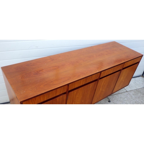 909 - A teak four door sideboard, 184cm long, missing one foot