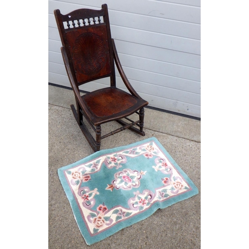 921 - A late Victorian rocking chair together with a small Chinese rug (2)