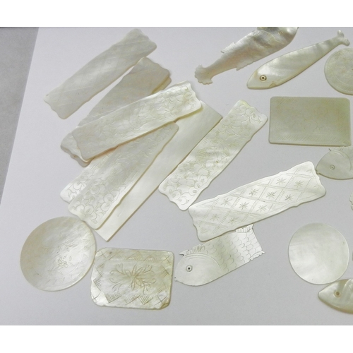 186 - A collection of Chinese mother of pearl gaming counters including fish-shaped and circular examples ... 