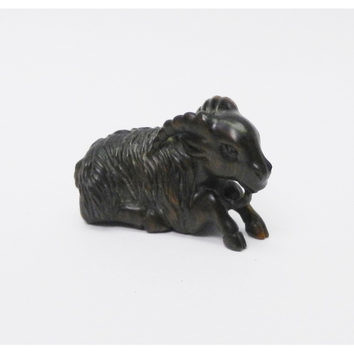 110 - A netsuke depicting a ram, signed to front leg, carved hardwood, 50mm long.