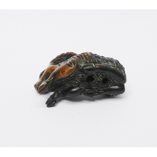 110 - A netsuke depicting a ram, signed to front leg, carved hardwood, 50mm long.