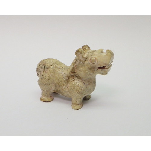 164 - A Chinese carved stone beast? rhinoceros? decorated with scroll motifs, 70mm long.