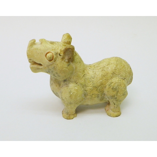 164 - A Chinese carved stone beast? rhinoceros? decorated with scroll motifs, 70mm long.