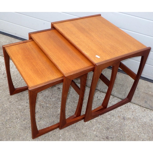 A teak nest of three occasional tables