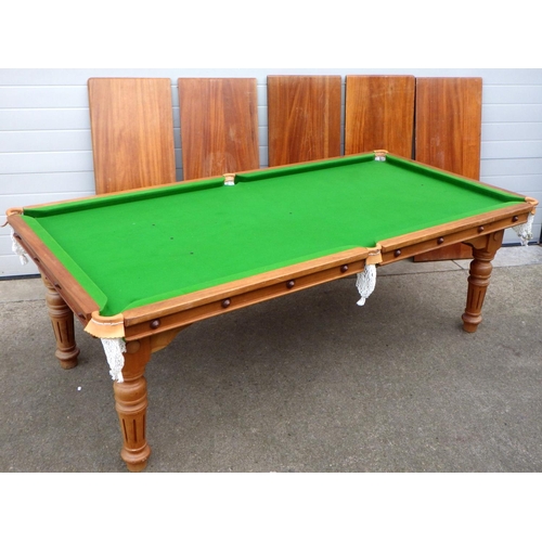 A snooker/dining table, 118cm x 226cm, on turned legs with 5 leaves, adjustable height brackets, stamped E.J. Riley