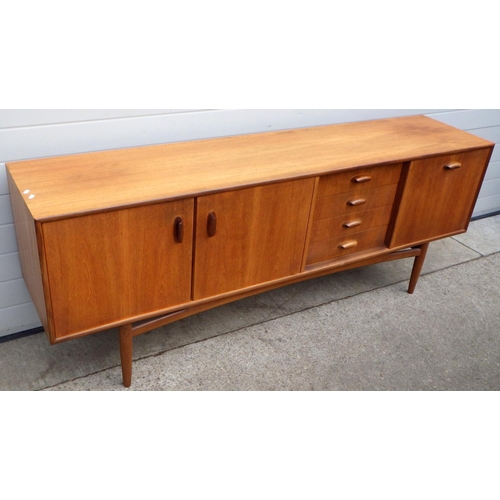  VICTOR WILKINS FOR G-PLAN; a 1960s Brasilia model 4058 teak sideboard, with double cabinet flanked b... 