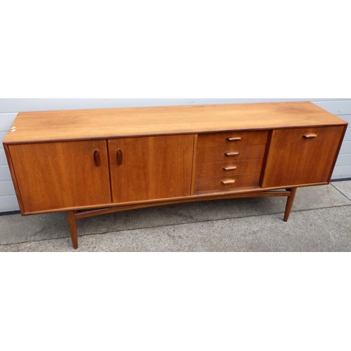  VICTOR WILKINS FOR G-PLAN; a 1960s Brasilia model 4058 teak sideboard, with double cabinet flanked b... 