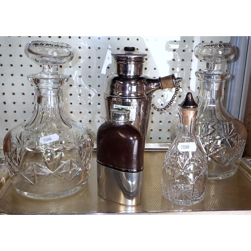 71 - A silver plated cocktail shaker together with a pair of decanters, hip flask and a condiment cut gla... 