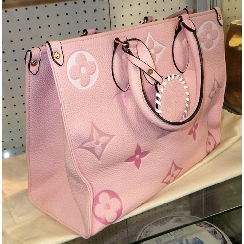 82 - A pink labelled handbag