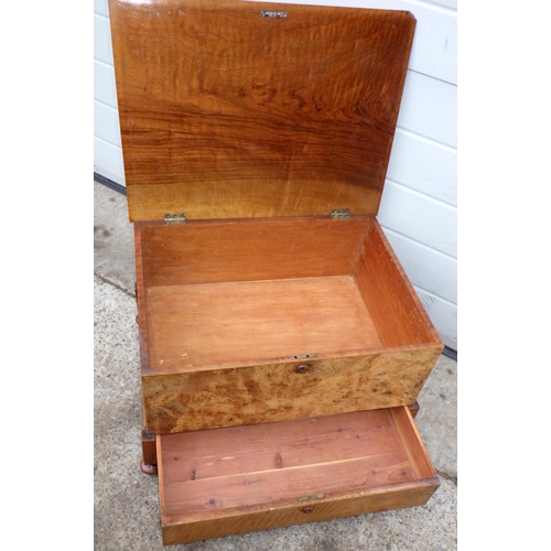 A burr walnut box with lower drawer, top warped, 57cm wide