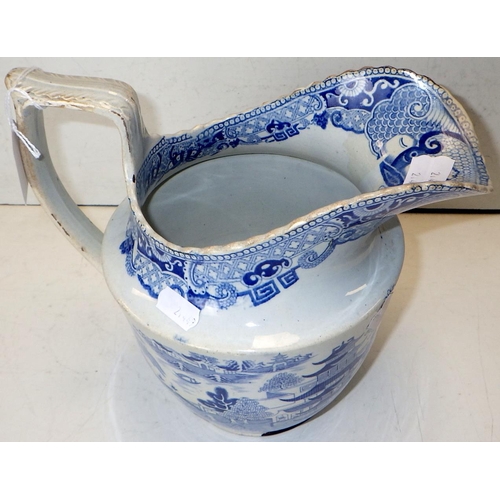 102 - An early 19thC willow pattern jug together with a 19thC hot water pot 22cm tall (2)